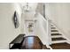 Inviting foyer featuring hardwood floors, staircase, and modern light fixture, creating a grand entrance at 4527 Central Ave, Indianapolis, IN 46205