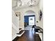 Stylish foyer with hardwood floors, an elegant staircase, and modern decor, showcasing the home's interior at 4527 Central Ave, Indianapolis, IN 46205