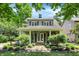 Charming two-story home with a covered front porch, manicured landscaping, and inviting curb appeal at 4527 Central Ave, Indianapolis, IN 46205