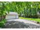 Detached two-car garage with mature landscaping and long driveway at 4527 Central Ave, Indianapolis, IN 46205