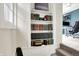 Hallway with stairs, a built-in bookcase, and view into office at 4527 Central Ave, Indianapolis, IN 46205