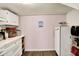 Small kitchen with white cabinets, wood-look flooring, and modern appliances for cooking at 4527 Central Ave, Indianapolis, IN 46205