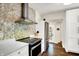 Contemporary kitchen featuring a mosaic backsplash, stainless steel appliances, and hardwood floors, adding sophistication at 4527 Central Ave, Indianapolis, IN 46205