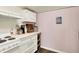Compact kitchen boasts white cabinets, modern appliances, and wood-look flooring at 4527 Central Ave, Indianapolis, IN 46205