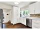 Well-lit kitchen boasting white cabinetry, stainless steel appliances, and hardwood floors, creating a functional space at 4527 Central Ave, Indianapolis, IN 46205