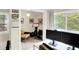 A bright office space with neutral walls, a large window, and a view of lush green trees at 4527 Central Ave, Indianapolis, IN 46205