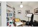 Office with white shelves filled with books, chair, wall art, and musical instruments at 4527 Central Ave, Indianapolis, IN 46205