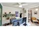 Office area with dual monitors, built-in shelving, decor, and a view into an adjacent room at 4527 Central Ave, Indianapolis, IN 46205