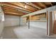 Unfinished basement featuring exposed ceiling, concrete floor, support beam and decorative wall accents at 5129 E 69Th St, Indianapolis, IN 46220