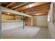 Spacious unfinished basement with exposed ceiling, concrete floors, support beam and stairs at 5129 E 69Th St, Indianapolis, IN 46220
