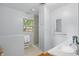 Bright bathroom featuring neutral paint, a window overlooking the yard, and tile flooring at 5129 E 69Th St, Indianapolis, IN 46220