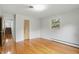 Bedroom featuring wood floors, light walls, and natural lighting from the window, creating a calming atmosphere at 5129 E 69Th St, Indianapolis, IN 46220