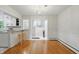 Bright dining room area featuring hardwood floors and an open view into the staircase and kitchen at 5129 E 69Th St, Indianapolis, IN 46220