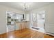 Bright dining room area featuring hardwood floors and an open view into the staircase and kitchen at 5129 E 69Th St, Indianapolis, IN 46220