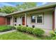 Charming single-story home with a manicured lawn and a combination of brick and light-colored siding at 5129 E 69Th St, Indianapolis, IN 46220
