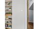 Hallway with built-in shelves adds character and storage, alongside a view of the thermostat and bedroom doorway at 5129 E 69Th St, Indianapolis, IN 46220