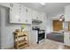 This cozy kitchen showcases an updated oven, white cabinets, and ample countertop space for food preparation at 5129 E 69Th St, Indianapolis, IN 46220