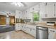 This kitchen features stainless steel appliances, white cabinets, plenty of countertop space, and lots of natural light at 5129 E 69Th St, Indianapolis, IN 46220