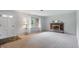 Bright living room with a brick fireplace, large windows, and neutral-toned carpeting at 5129 E 69Th St, Indianapolis, IN 46220