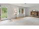 Bright living room with a brick fireplace, large windows, and neutral-toned carpeting at 5129 E 69Th St, Indianapolis, IN 46220