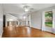 Spacious living room with hardwood floors, a vaulted ceiling, and large windows for ample natural light at 5129 E 69Th St, Indianapolis, IN 46220