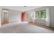 Bright living room with a brick fireplace, large windows, and neutral-toned carpeting at 5129 E 69Th St, Indianapolis, IN 46220