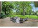 Outdoor brick patio with outdoor furniture and large shade tree in beautiful backyard setting at 5129 E 69Th St, Indianapolis, IN 46220