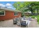 Brick patio area with furniture with a view of the backyard and exterior of the home at 5129 E 69Th St, Indianapolis, IN 46220
