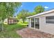 Backyard featuring a shed, patio, and a large grassy area surrounded by trees at 518 N Carr Rd, Plainfield, IN 46168