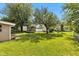 This private backyard showcases a lush lawn, garden area, shed, and mature trees at 518 N Carr Rd, Plainfield, IN 46168