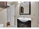 This bathroom features a dark vanity, neutral walls, and a large mirror at 518 N Carr Rd, Plainfield, IN 46168