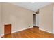 Bedroom features hardwood floors and a practical layout with convenient access to closet and hallway at 518 N Carr Rd, Plainfield, IN 46168