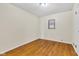 Cozy bedroom with hardwood floors, a neutral color scheme, and a window bringing in natural light at 518 N Carr Rd, Plainfield, IN 46168