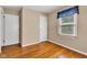 Bedroom with hardwood floors, soft natural light, and ample closet space for comfortable living at 518 N Carr Rd, Plainfield, IN 46168