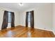 This spacious bedroom has hardwood flooring, providing an inviting space with views through the windows at 518 N Carr Rd, Plainfield, IN 46168