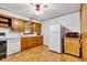 Eat-in kitchen with linoleum floors, wood cabinets, and a white refrigerator at 518 N Carr Rd, Plainfield, IN 46168