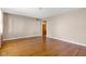 Spacious living room featuring gleaming hardwood floors and neutral walls, creating a warm and inviting atmosphere at 518 N Carr Rd, Plainfield, IN 46168