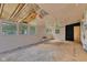 Large living room featuring unfinished floors, white walls, and many windows at 518 N Carr Rd, Plainfield, IN 46168