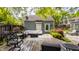 Backyard featuring deck with lounge furniture, patio seating, and lush landscaping at 5219 N New Jersey St, Indianapolis, IN 46220