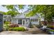Backyard patio with an outdoor seating area, garden beds, and lush greenery at 5219 N New Jersey St, Indianapolis, IN 46220