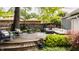 Wooden deck with patio seating, potted plants, and lush landscaping in backyard at 5219 N New Jersey St, Indianapolis, IN 46220