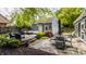 Backyard features deck and patio areas with stylish seating, landscaping, and detached garage at 5219 N New Jersey St, Indianapolis, IN 46220