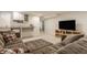 Cozy basement featuring an oversized gray sectional, a mini bar and lots of light at 5219 N New Jersey St, Indianapolis, IN 46220