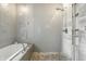Modern bathroom showcasing a luxurious soaking tub and glass-enclosed shower with stylish gray tiles at 5219 N New Jersey St, Indianapolis, IN 46220
