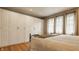 Bedroom featuring a large wardrobe, neutral colors, and hardwood floors for a cozy atmosphere at 5219 N New Jersey St, Indianapolis, IN 46220
