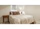 Basement bedroom features neutral color scheme and natural wood side table at 5219 N New Jersey St, Indianapolis, IN 46220