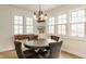 Charming dining area with elegant chandelier, built-in shelving, and large windows offering ample natural light at 5219 N New Jersey St, Indianapolis, IN 46220