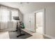 Bright exercise room with an exercise bike and multiple windows covered by sheer white curtains at 5219 N New Jersey St, Indianapolis, IN 46220