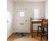The home features a classic foyer with a decorative table and chair situated near the white front door at 5219 N New Jersey St, Indianapolis, IN 46220