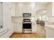 Modern kitchen with stainless steel appliances and white cabinetry at 5219 N New Jersey St, Indianapolis, IN 46220